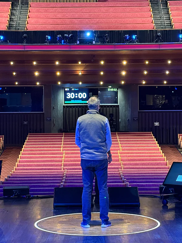 Speaker on stage at Grand Ole Opry with 30:00 countdown timer displayed prominently above the empty auditorium seating